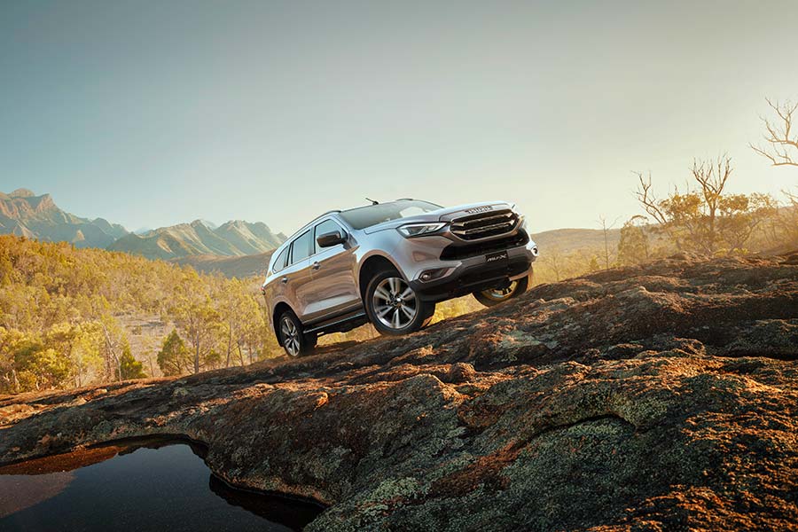 2024 Isuzu MU-X SUV parked on rocks